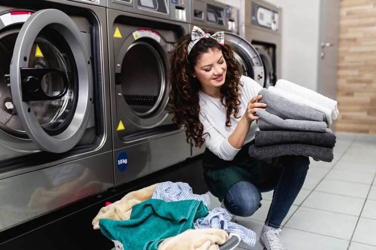 beautiful-female-employee-working-laundromat-shop_473712-1969