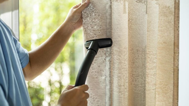 man-dry-cleaning-curtain-with-vacuum-cleaner-living-room-home_47274-173