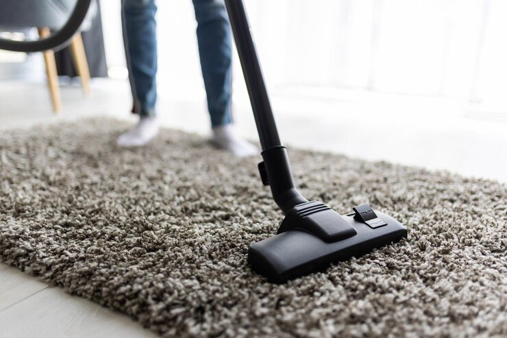 people-housework-housekeeping-concept-close-up-woman-with-legs-vacuum-cleaner-cleaning-carpet-home_231208-13612